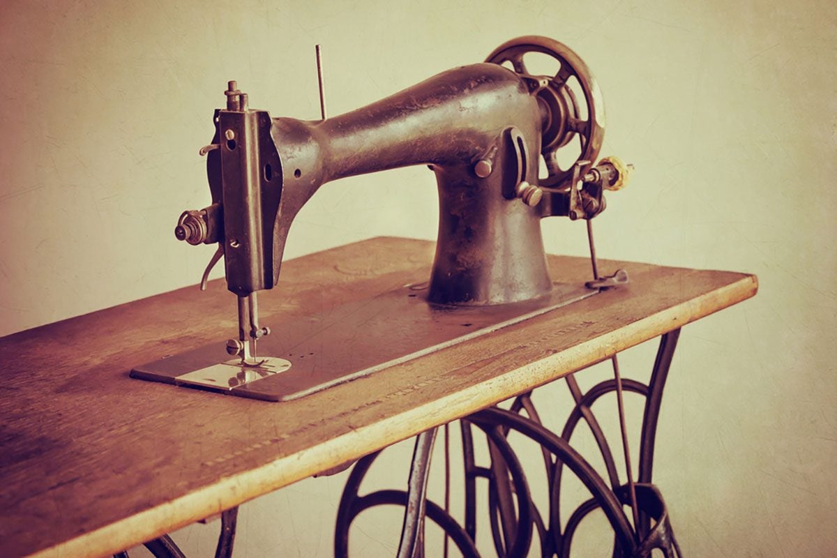 Old sewing machine on textured vintage background