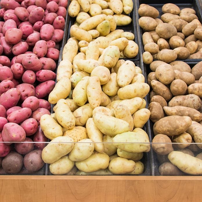 Different varieties of potatoes in a shelf in a grocery store