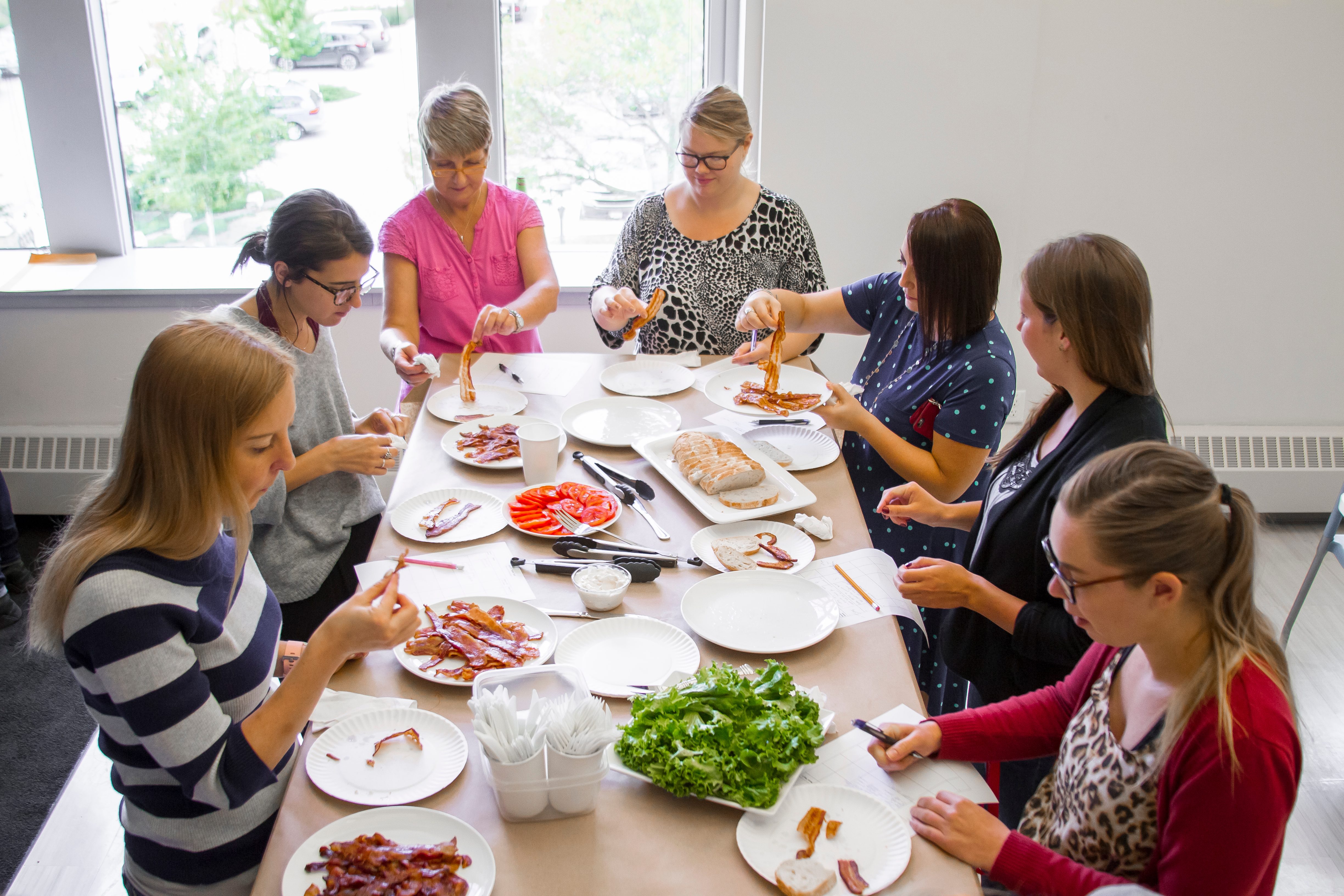 Taste testers debating about bacon