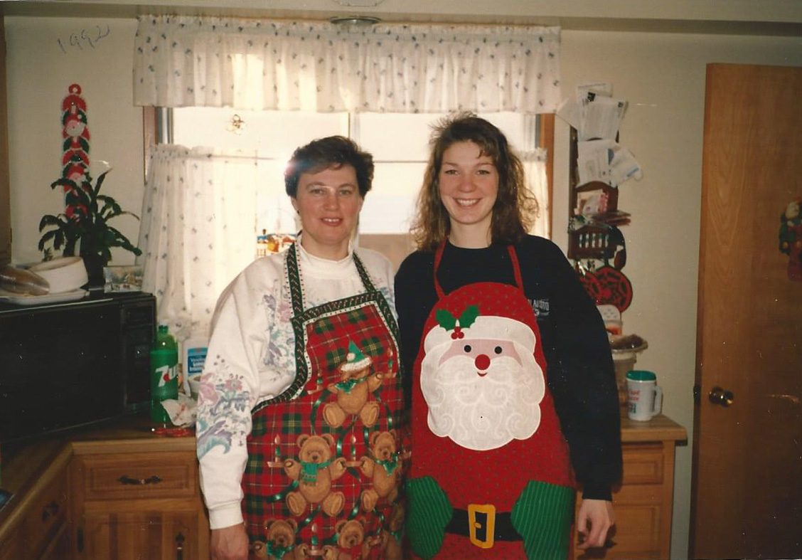 Mother and daughter get ready to bake together in their festive aprons