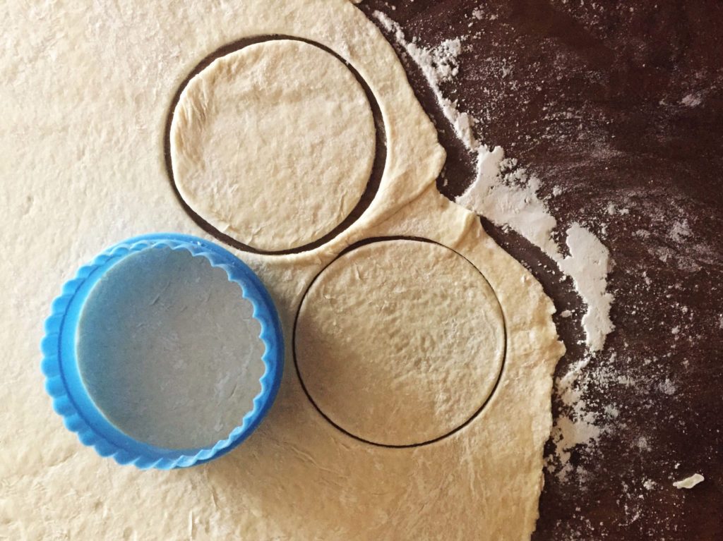 Two circular cut-outs from the flattened dough