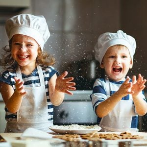 happy family funny kids are preparing the dough, bake cookies in the kitchen