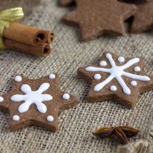 Star shape Christmas chocolate gingerbread Cookie with icing and cinnamon on sacking