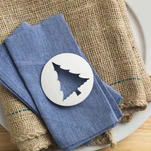 Plastic tree shaped biscuit cutter on blue napkin