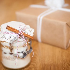 Dry mixing ingredients for chocolate chip cookies in a glass jar handmade gift