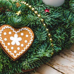 Advent Christmas wreath made natural pine with Heart shaped gingerbread cookie