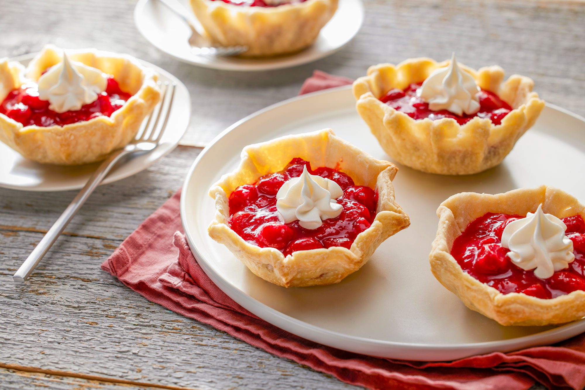 Cherry Tarts Served in a Plate on Wooden Surface
