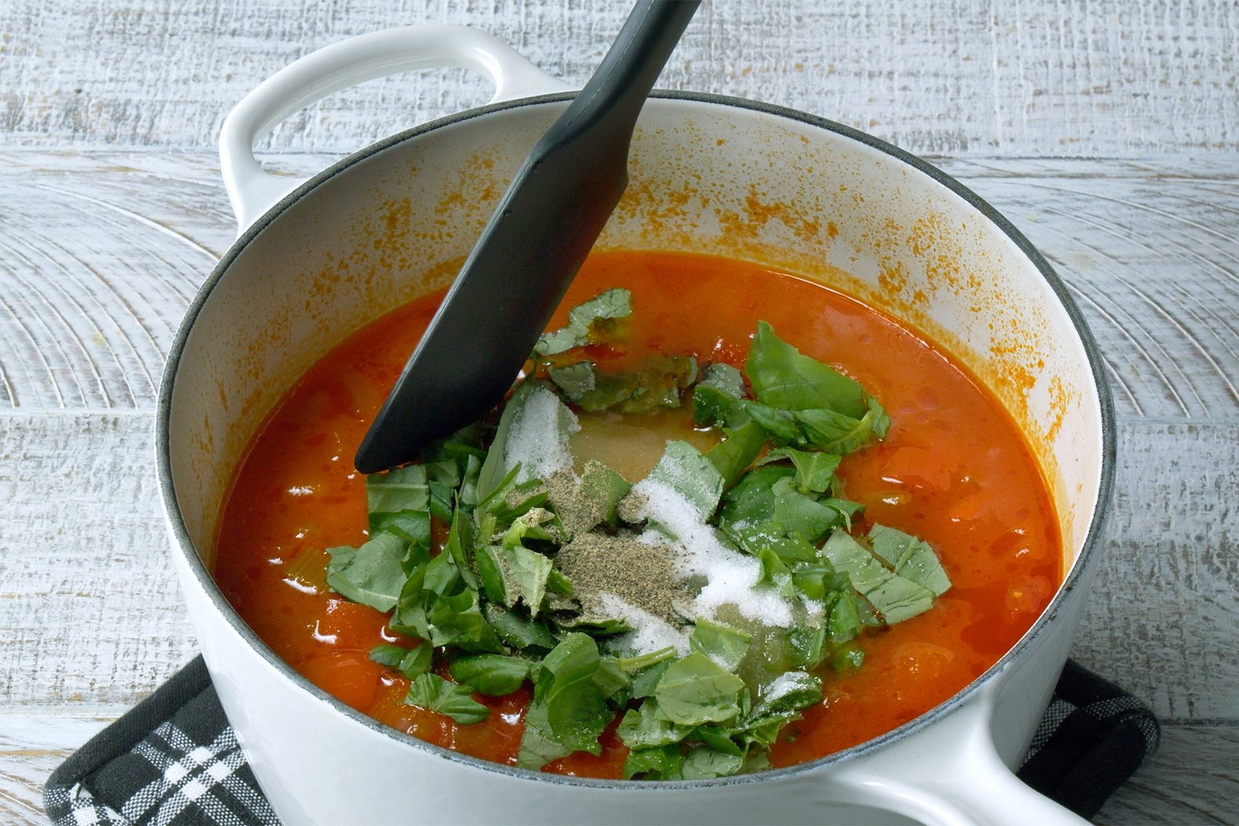 Stir in the basil, sugar, salt and pepper