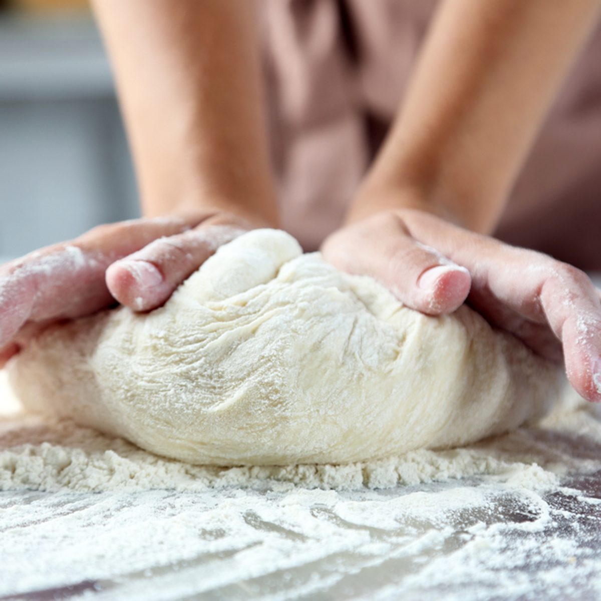 Making dough by female hands at bakery; Shutterstock ID 321264986