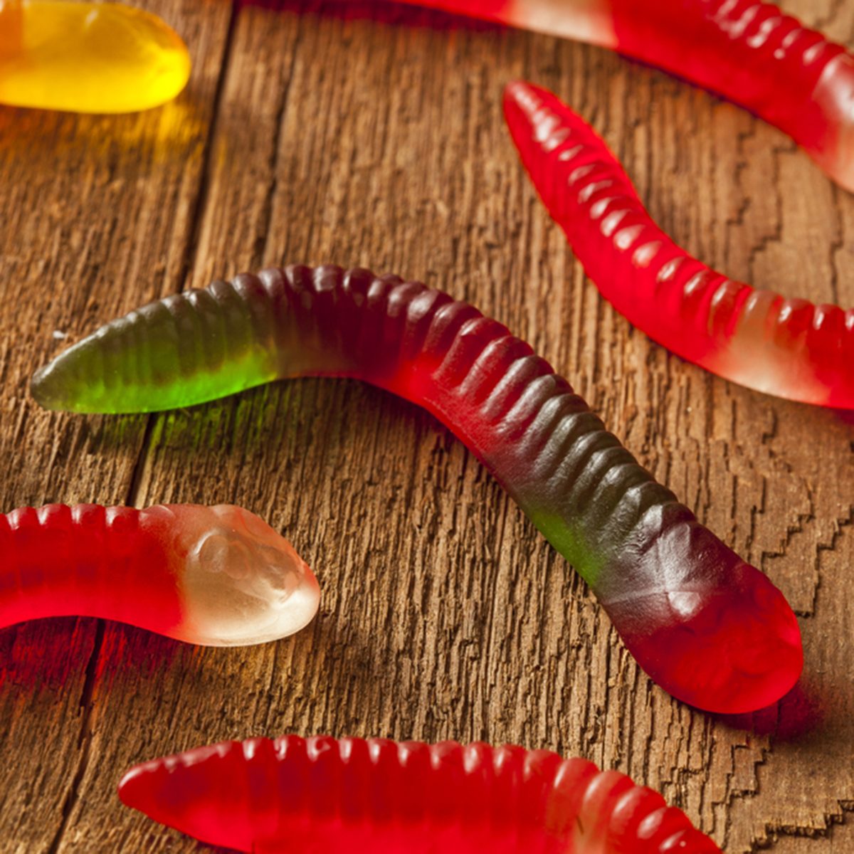 Colorful Fruity Gummy Worm Candy on a background; Shutterstock ID 144909937