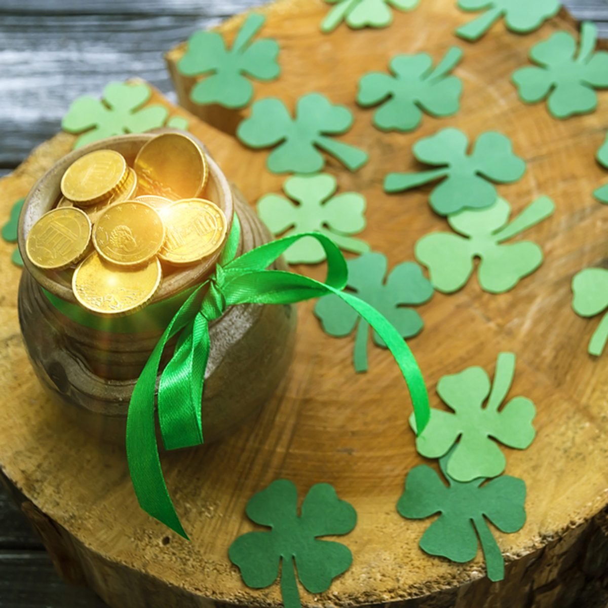 Happy St Patrick's Day concept, March 17, Shiny Pot of Gold Leprechaun and clover trefoils on wooden stump.; Shutterstock ID 600881663