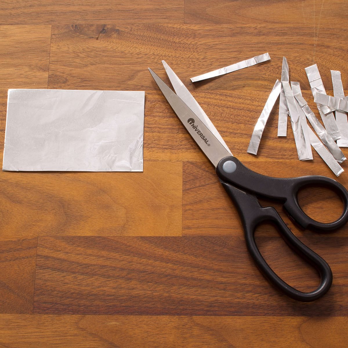 Using scissors to cut foil