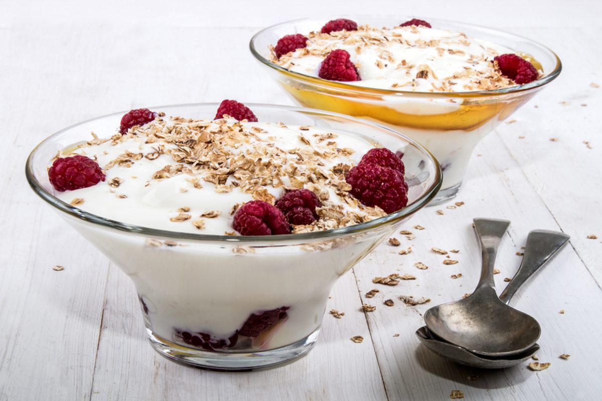 cranachan with raspberry, whipped cream and roasted oatmeal in a glass