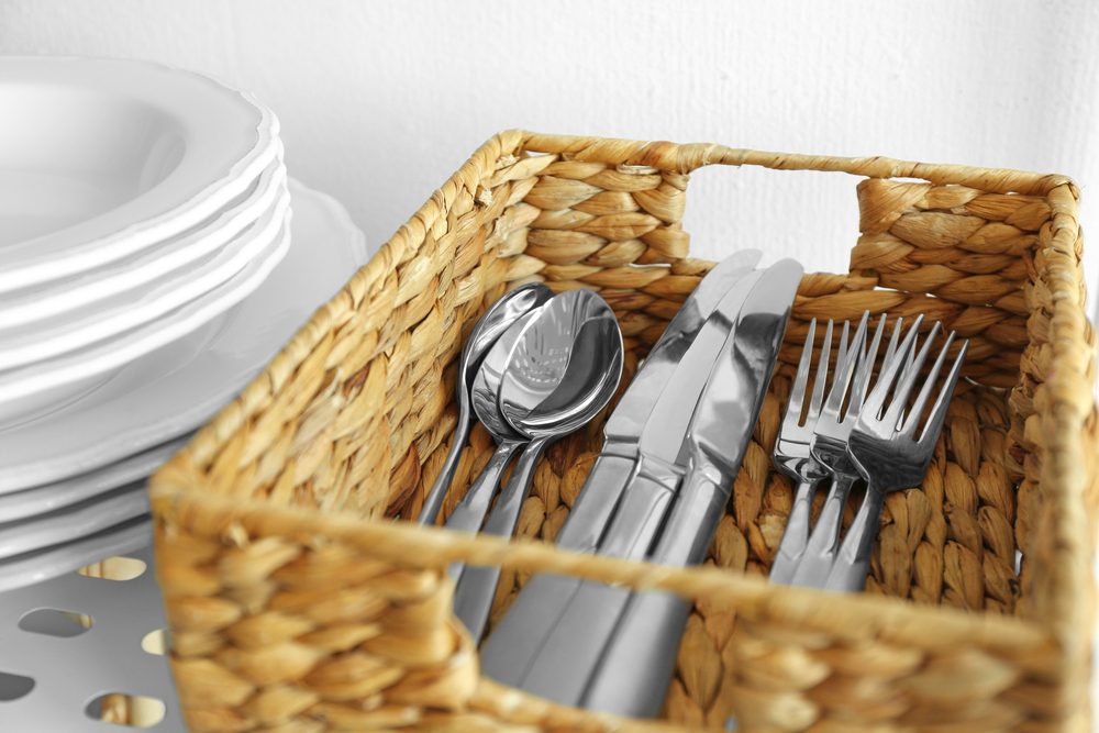 Cutlery in wicker basket on shelf; 