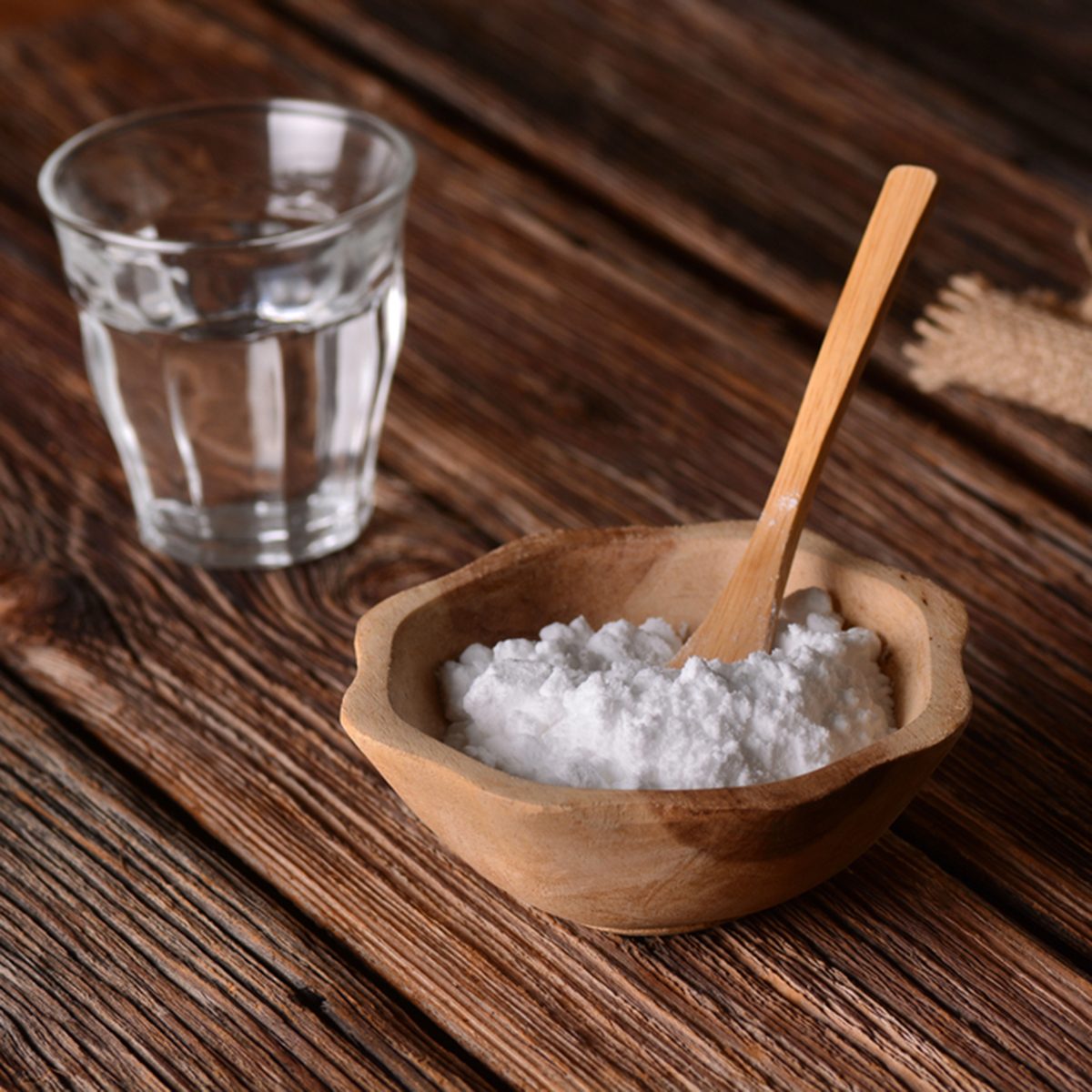 baking soda into the bowl with wooden spoon