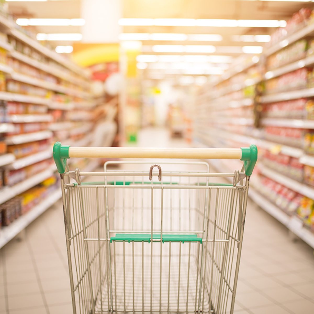 Supermarket interior, empty red shopping cart