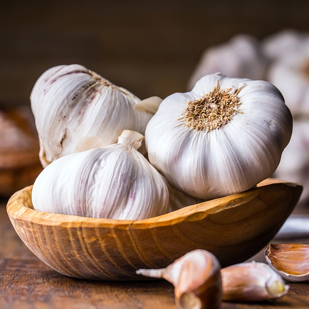 Garlic Cloves and Bulb in vintage wooden bowl