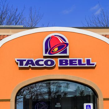 Exterior of Taco Bell fast-food restaurant with sign and logo.