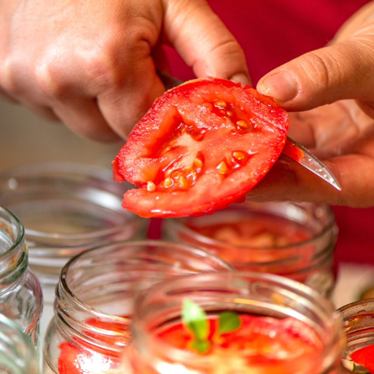 Canning fresh tomatoes with onions in jelly marinade.