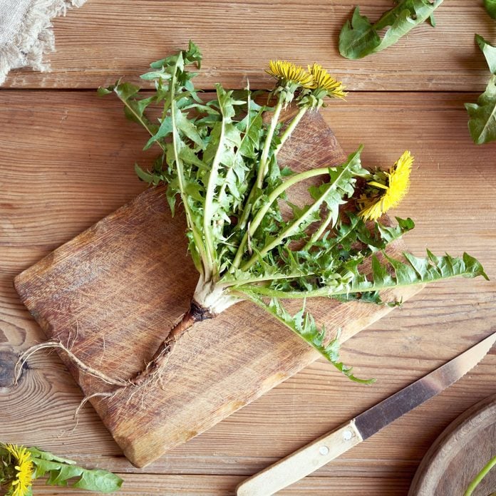 dandelions on a wooden cutting board