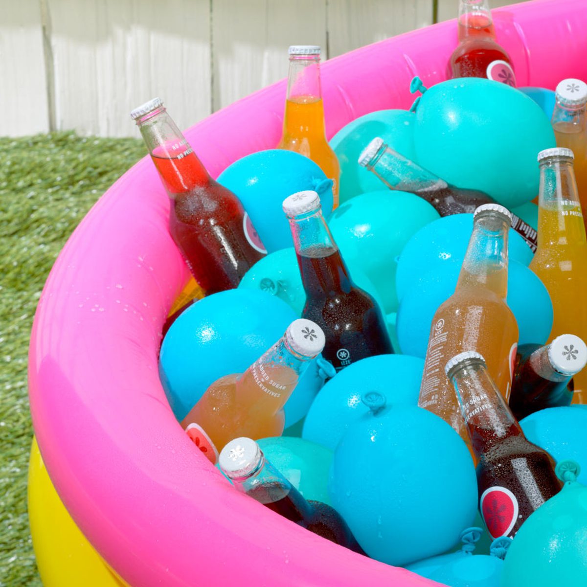 Kiddie pool filled with frozen water balloons and drinks