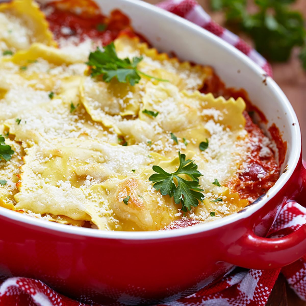 Baked ravioli with ham and cheese in tomato sauce