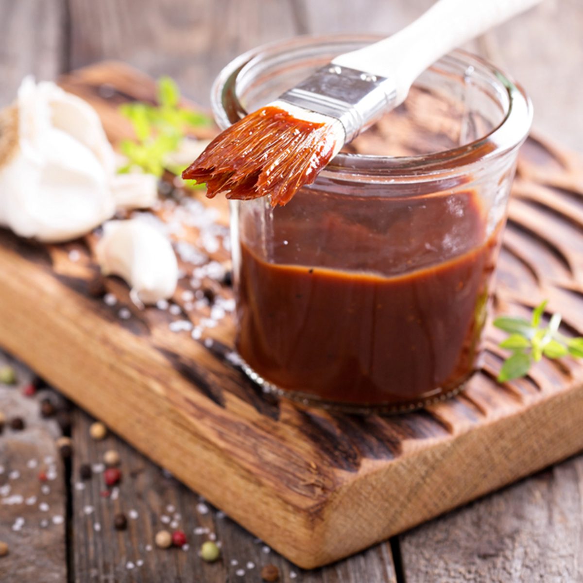 Barbeque sauce with a basting brush in a jar