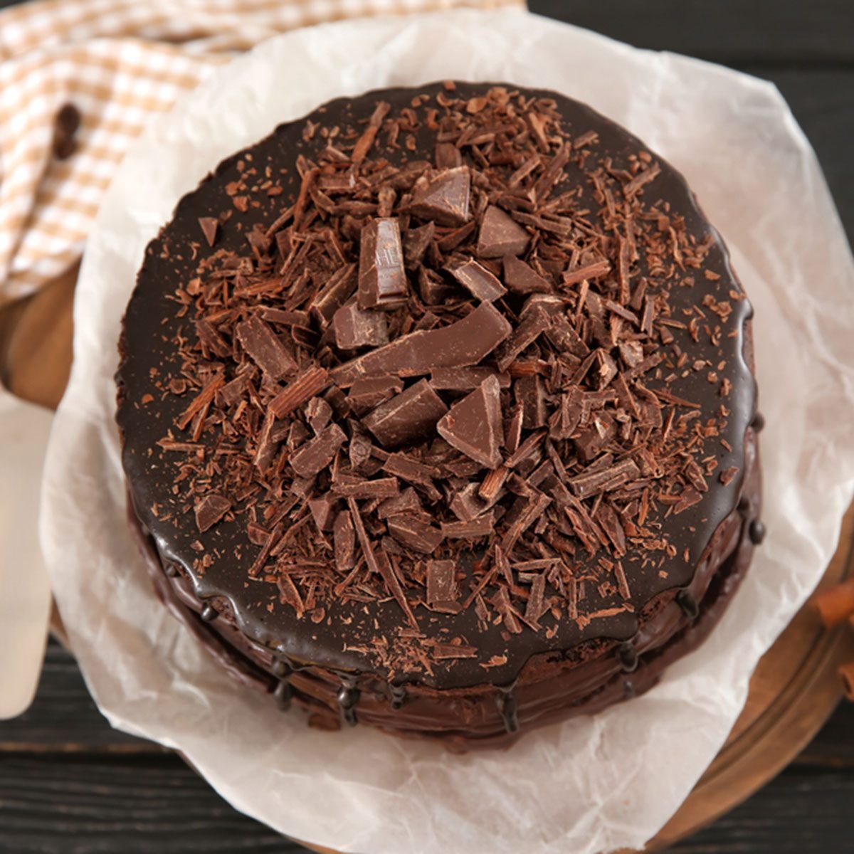 Board with delicious chocolate cake on wooden table; Shutterstock ID 1156703284; Job (TFH, TOH, RD, BNB, CWM, CM): Taste of Home