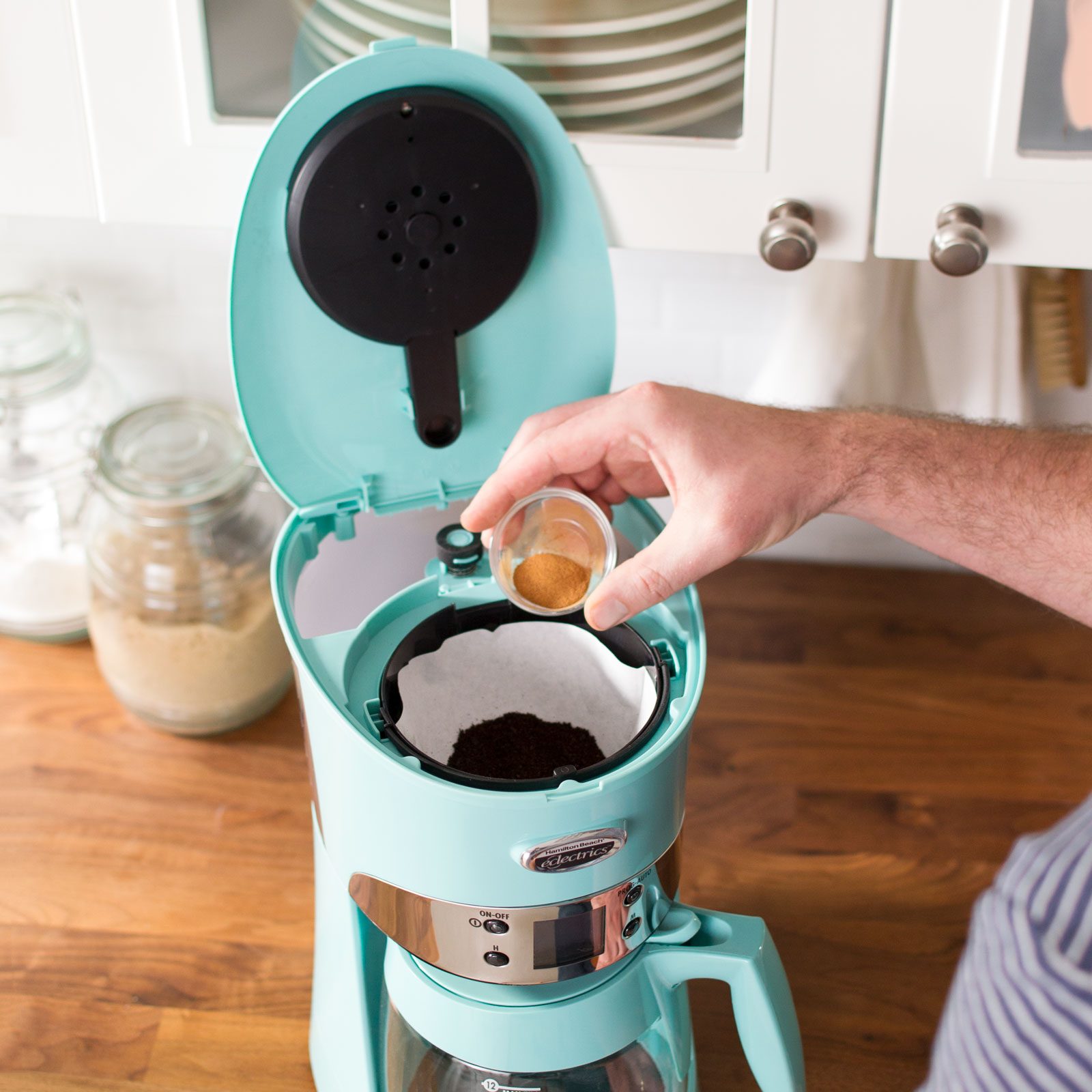 putting spices into a coffee maker