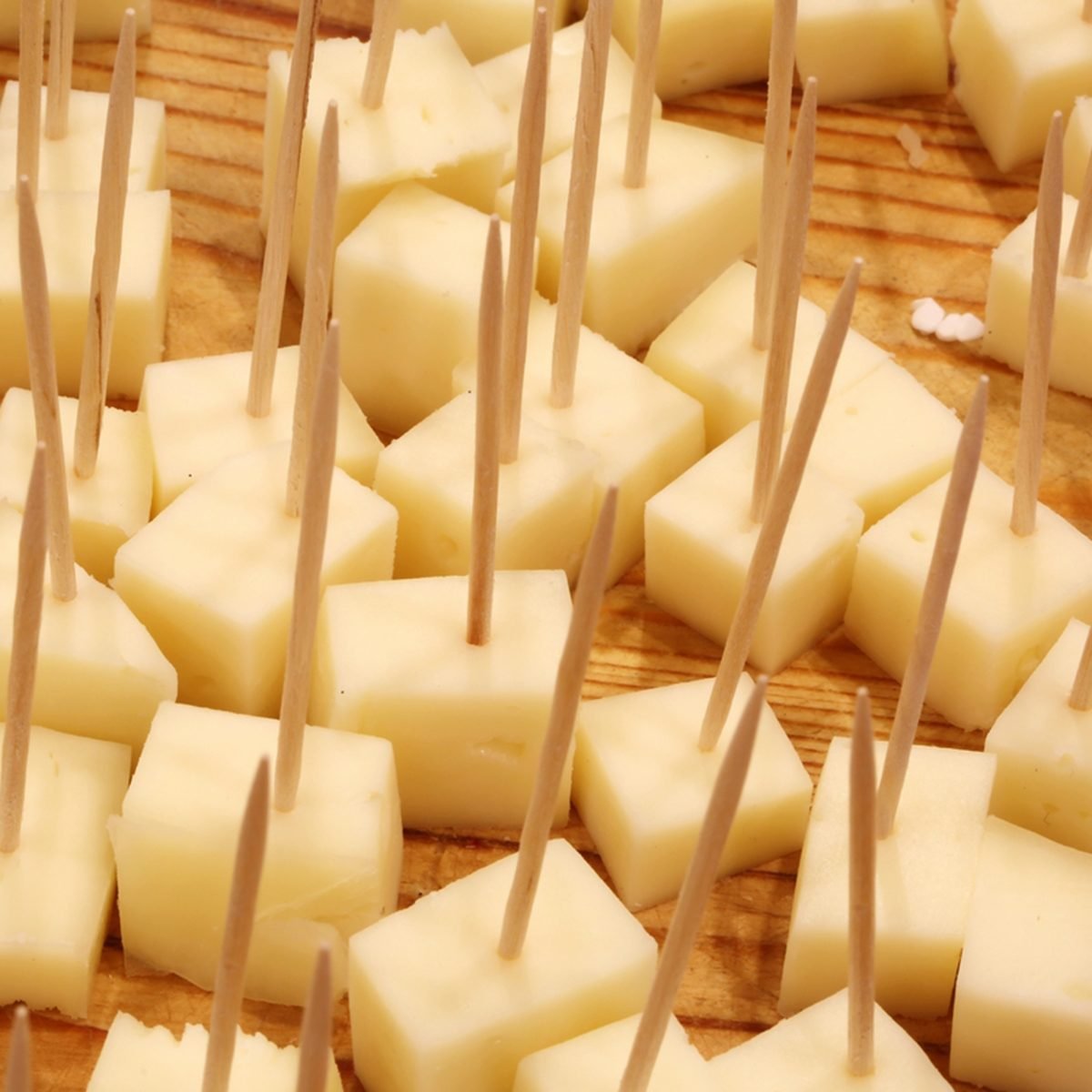 fresh cheese tastings with toothpicks in the cheese shop over the cutting board