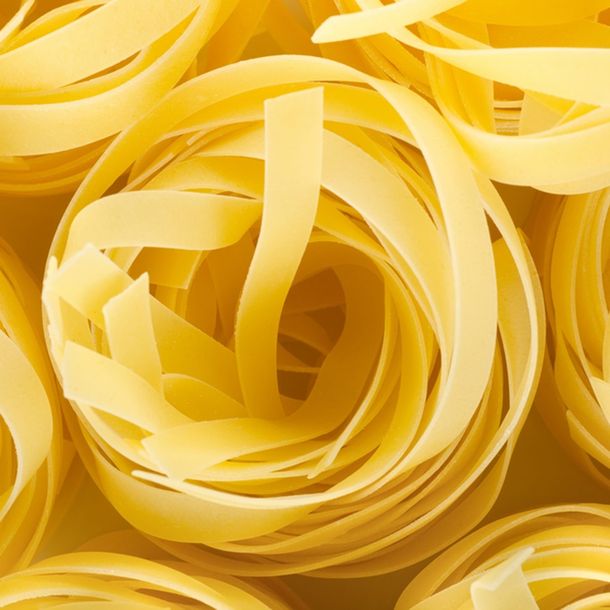 Photo of the yellow raw pasta background