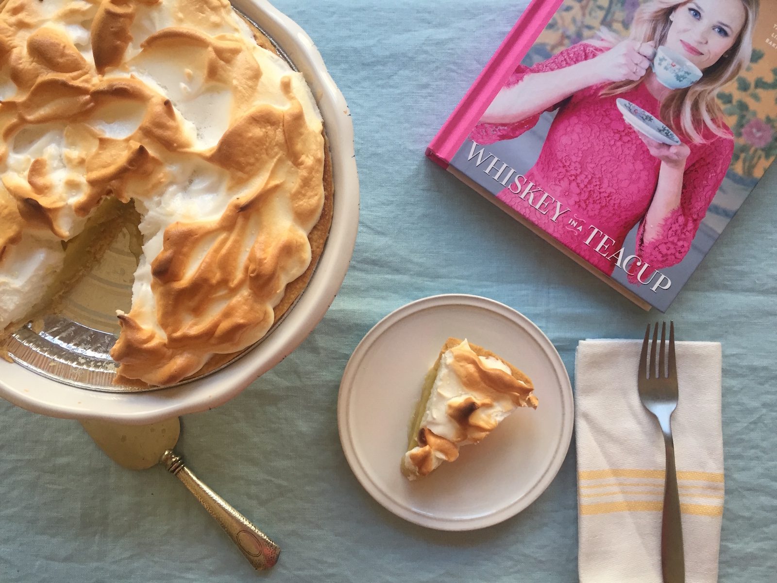 Reese Whiterspoon's Whiskey in a Teacup book with a lemon meringue pie