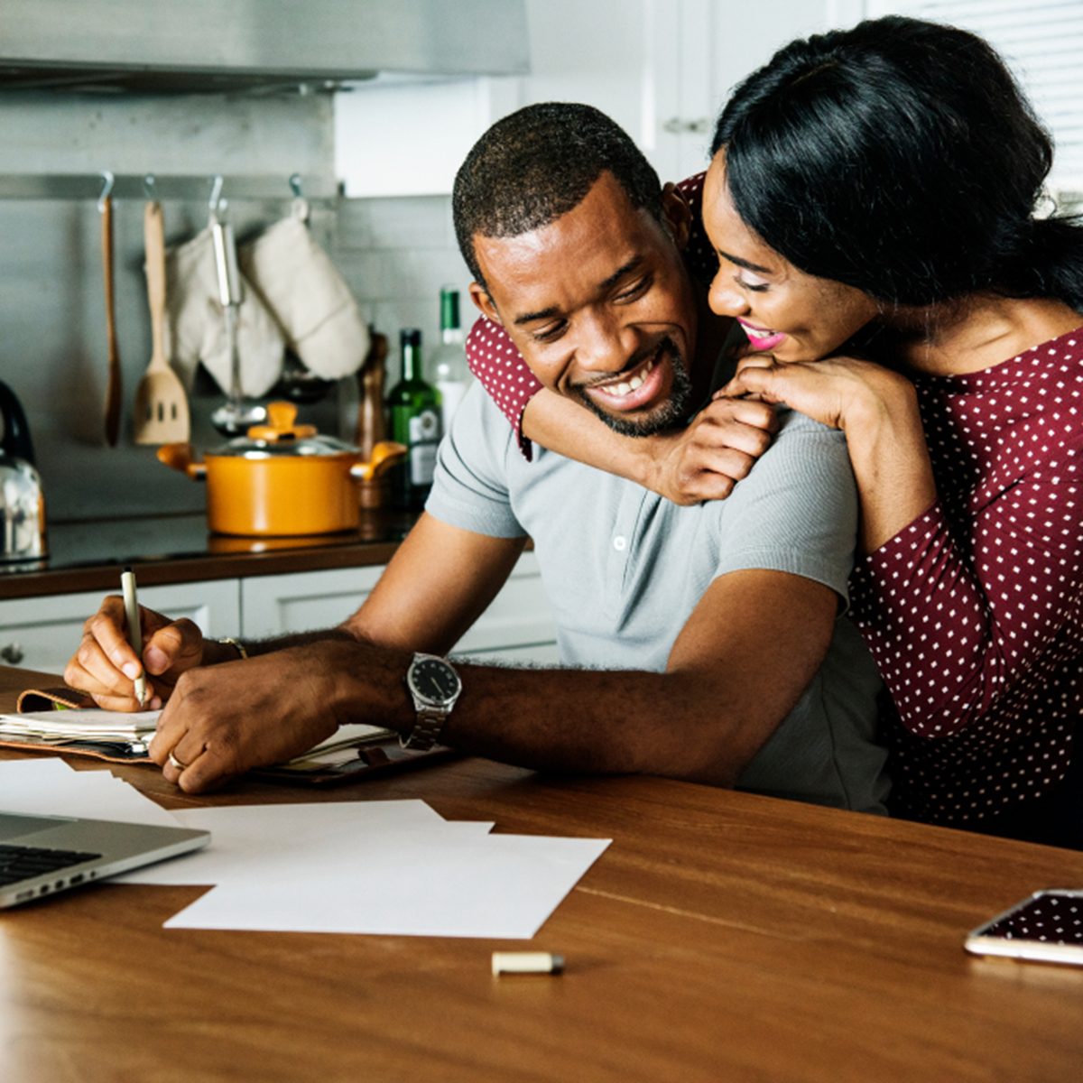 Black couple hugging together