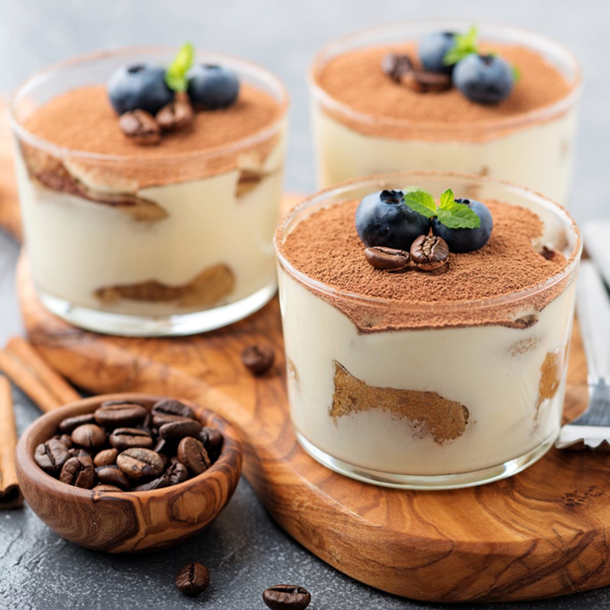 Classic tiramisu in a glass on a gray background.