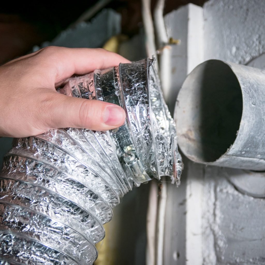 Flexible aluminum dryer vent hose, removed for cleaning/repair/maintenance. ; Shutterstock ID 1156231702