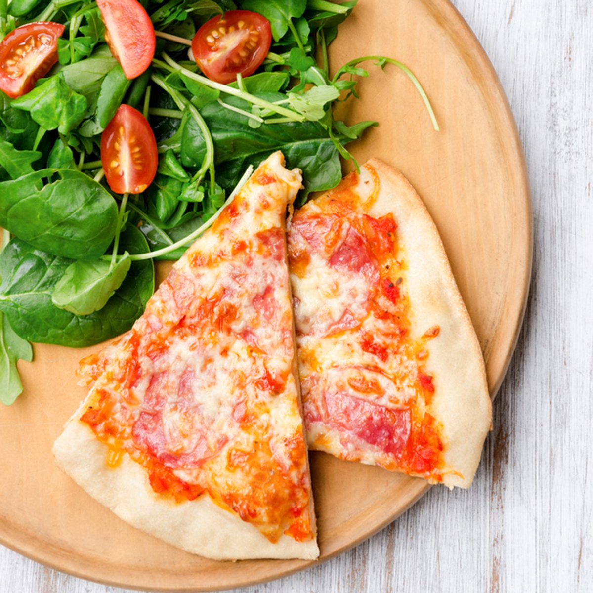 Pizza with salad for a balanced meal, overhead perspective