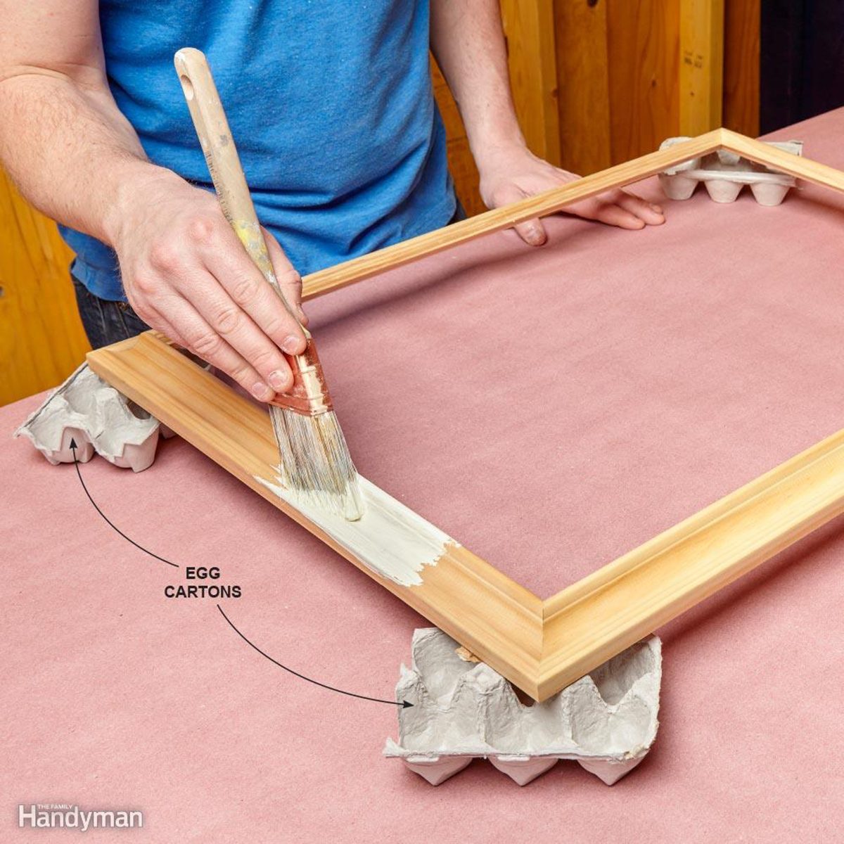 Using egg cartons to hold up a frame being painted