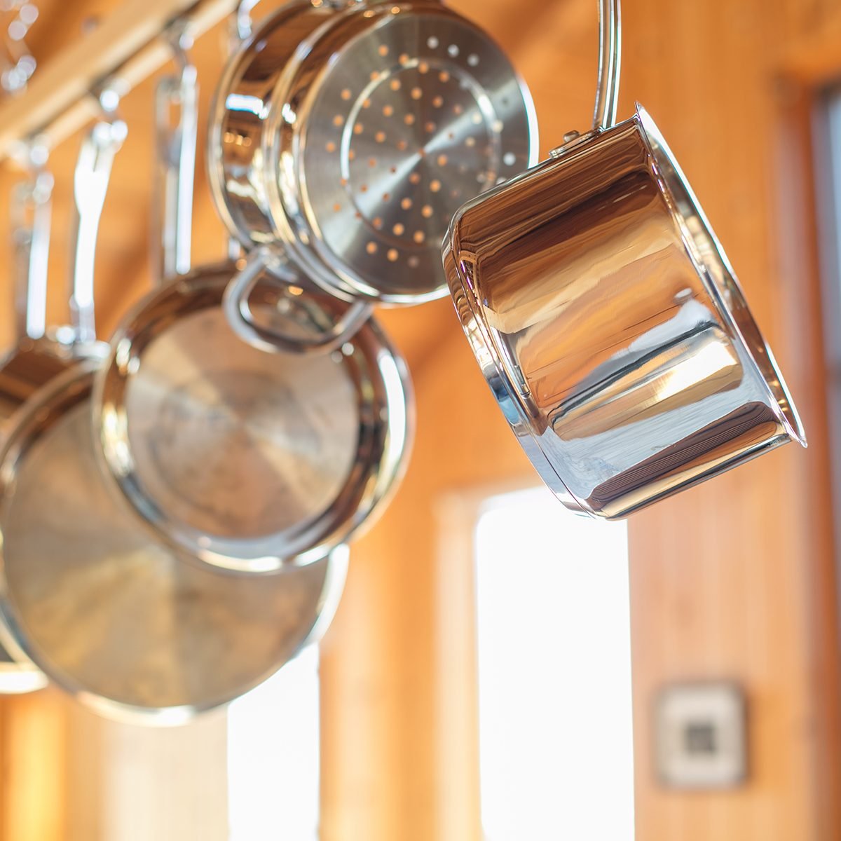 https://www.tasteofhome.com/wp-content/uploads/2019/04/pots-and-pans-hanging-in-kitchen-from-wood-rack-GettyImages-1064003760.jpg?fit=700%2C1024
