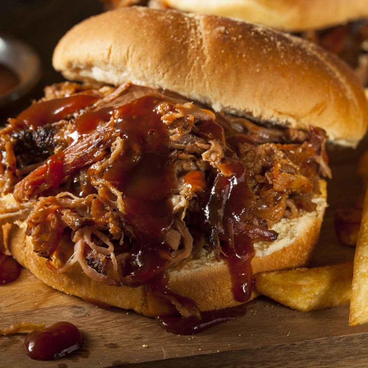 Barbeque Pulled Pork Sandwich with BBQ Sauce and Fries