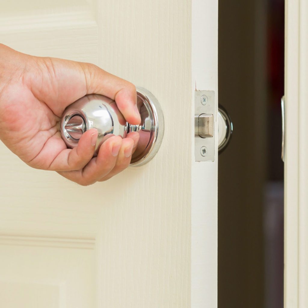 Man hand open door knob; Shutterstock ID 134272517