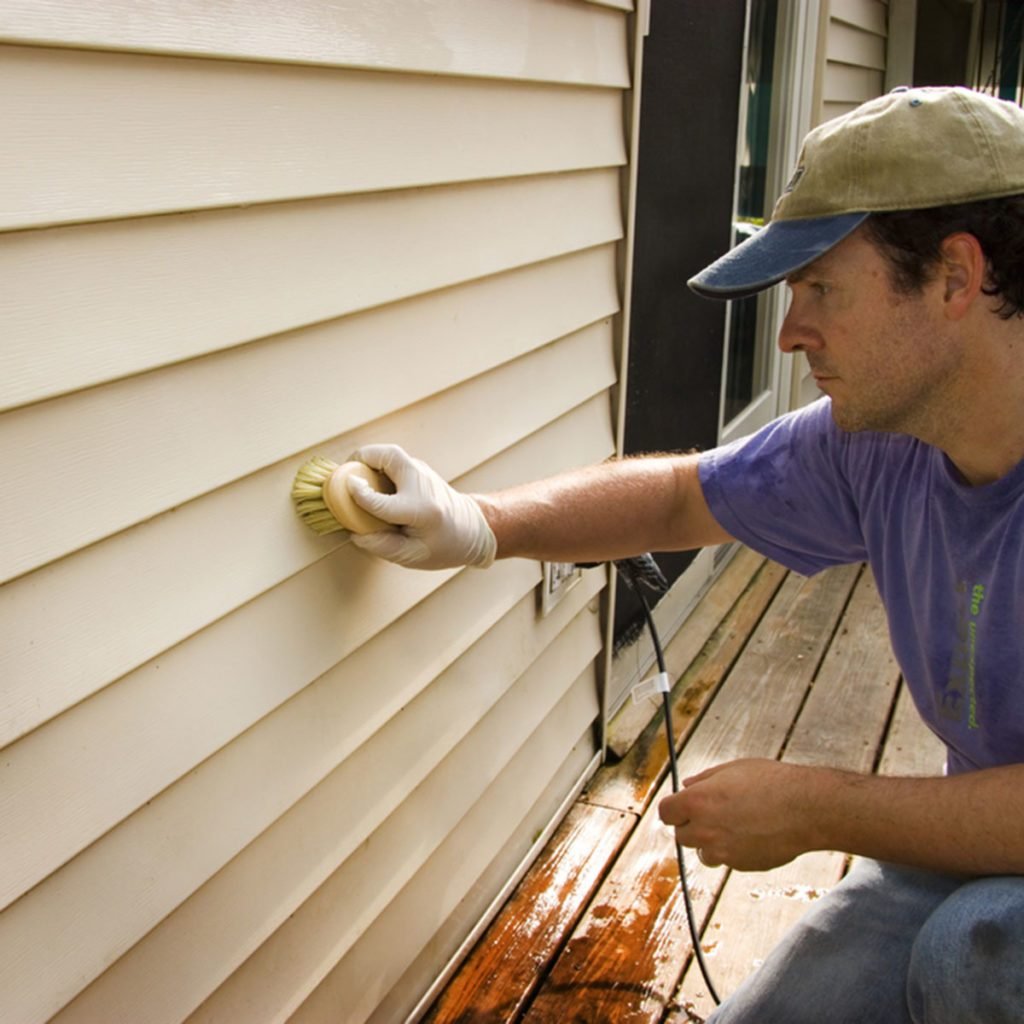 Man washing vinyl siding by hand with brush; Shutterstock ID 216426367; Job (TFH, TOH, RD, BNB, CWM, CM): Taste of Home