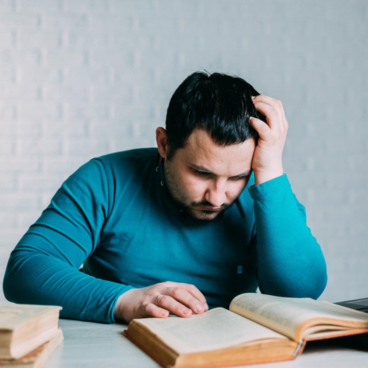 Man reading a book and nervous screams can't remember