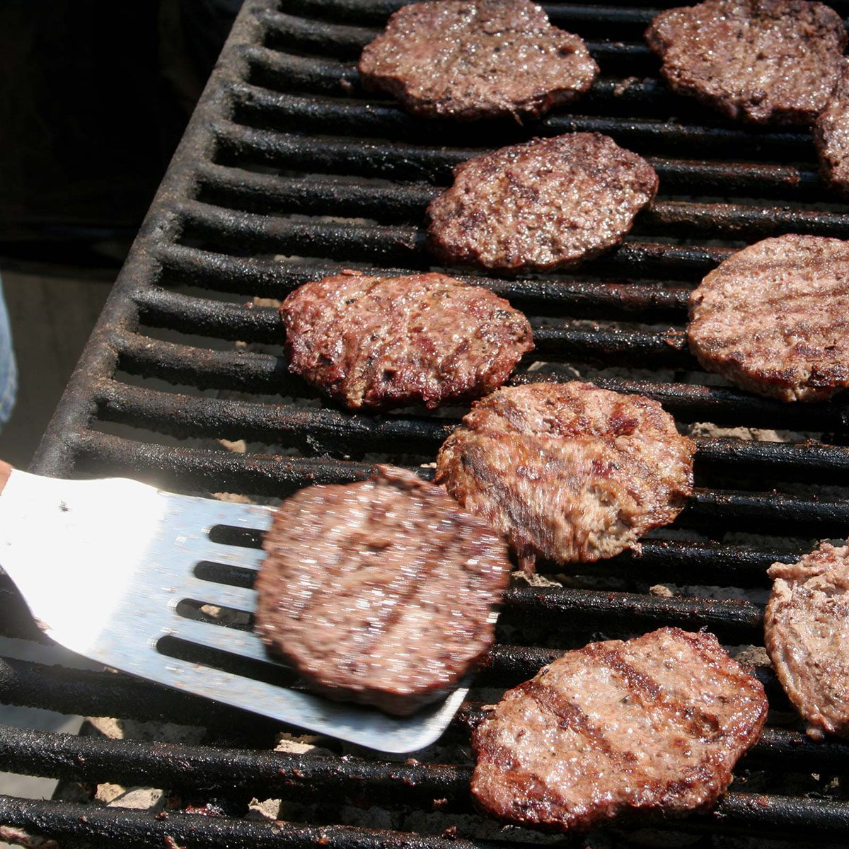 Flipping burgers on a grill