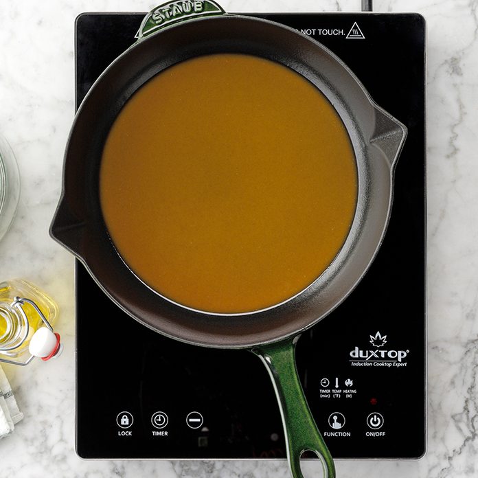 Caramel Roux in a saucepan on a hot plate on a marble countertop