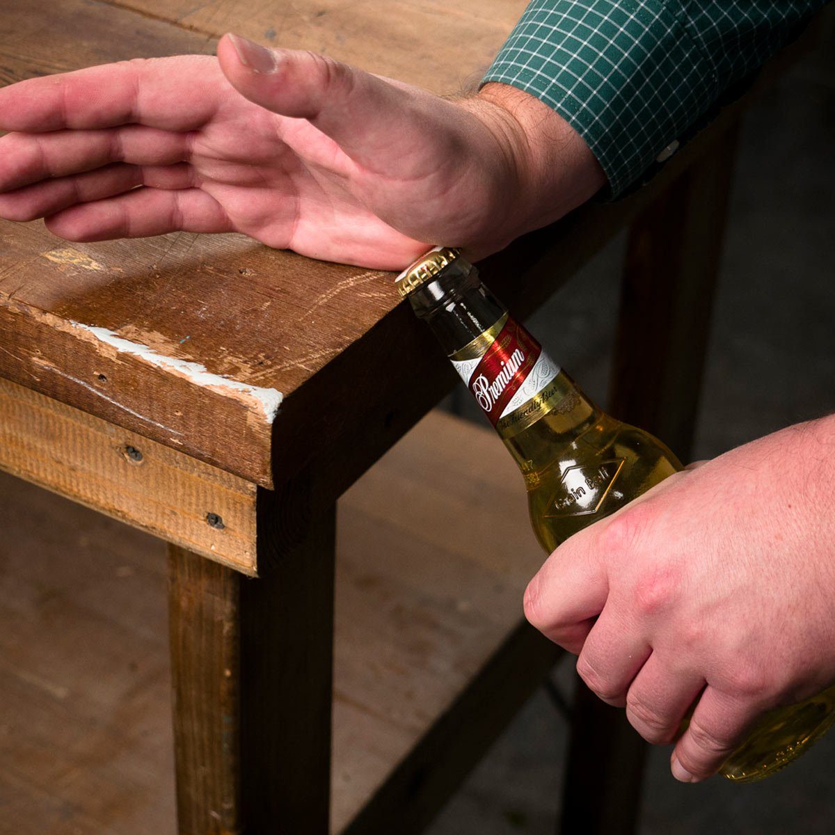 Opening bottle on the edge of a table
