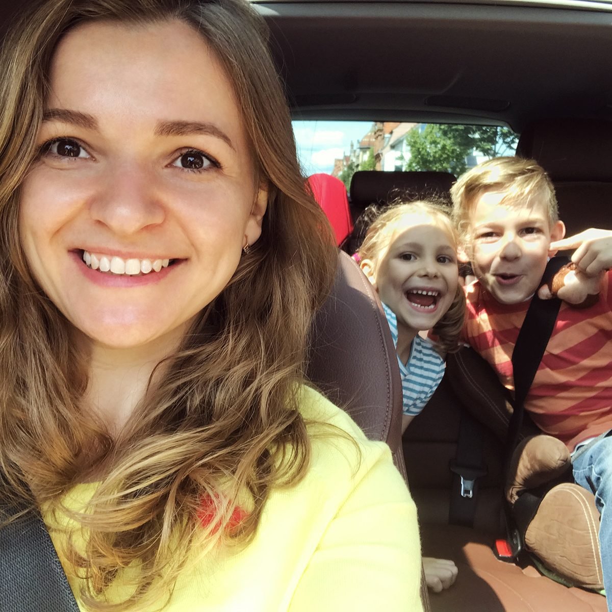 Family selfie photo in car during summer vacation