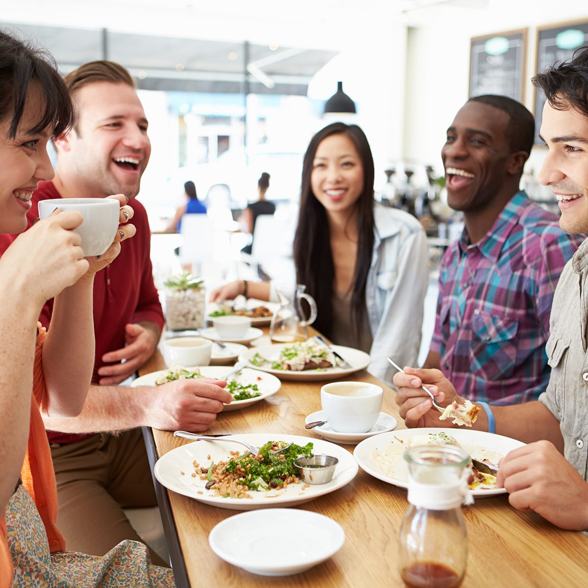 Group Of Friends Meeting For Lunch In Coffee Shop