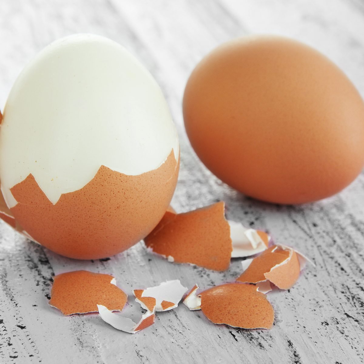 Peeled boiled egg on wooden background