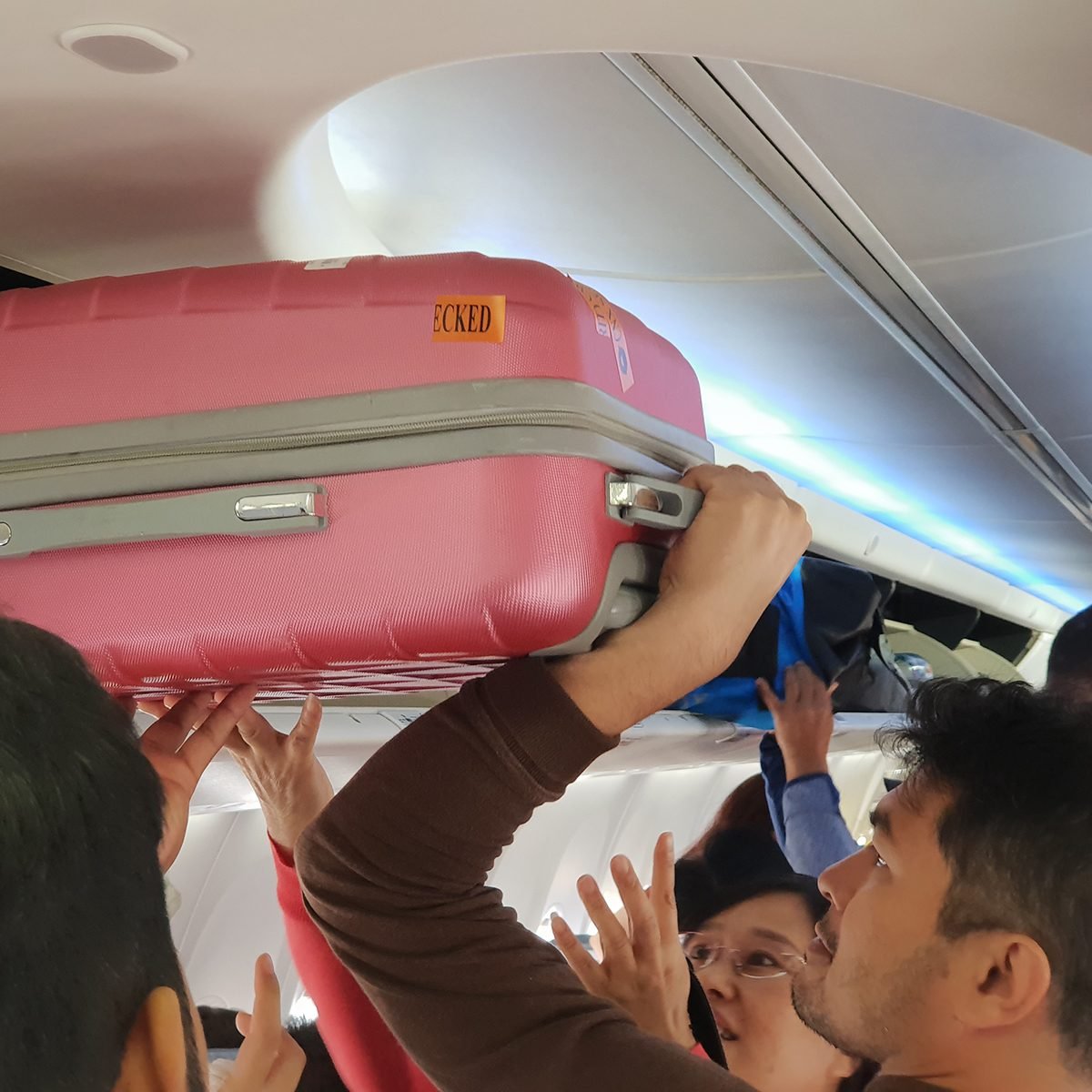 Bangkok, Thailand, 25 OCT 2018 Man put luggage cabin compartment. To the passengers on the plane.Blur softfocus.; Shutterstock ID 1243444021