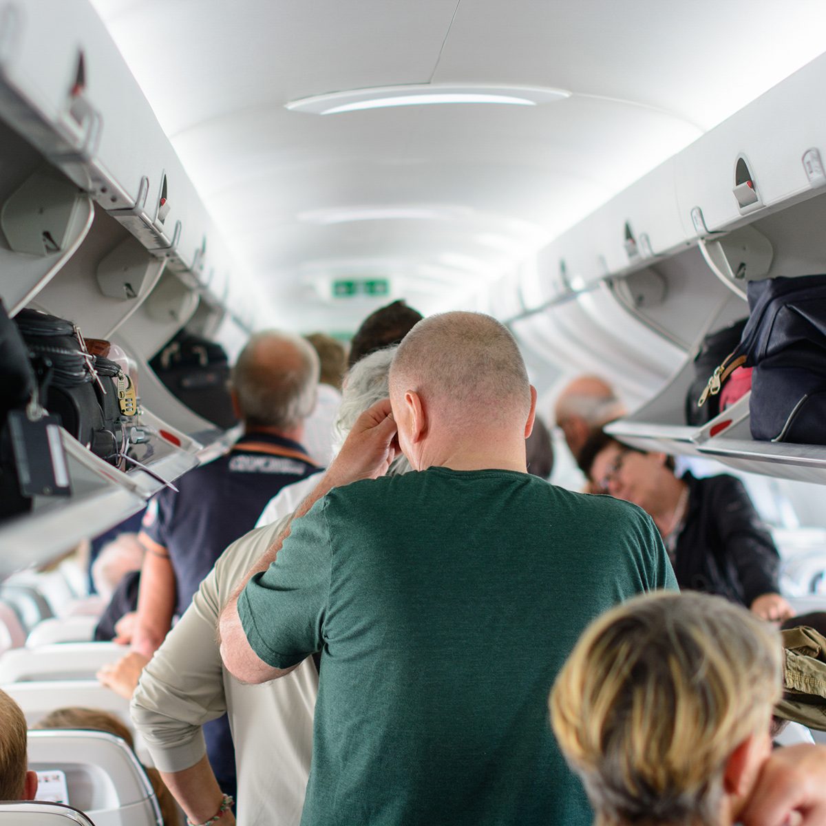 Budapest, Hungary - 25th May, 2017. People are standing and sitting in an airplane cabin before disembarking.; Shutterstock ID 663561313